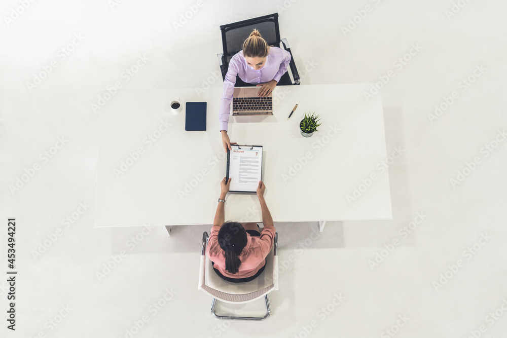 Two young business women in meeting at office table for job application and business agreement. Recr