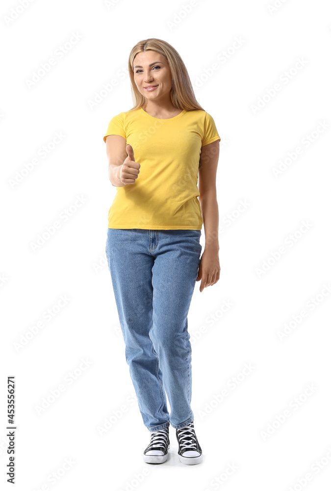 Portrait of stylish woman showing thumb-up on white background