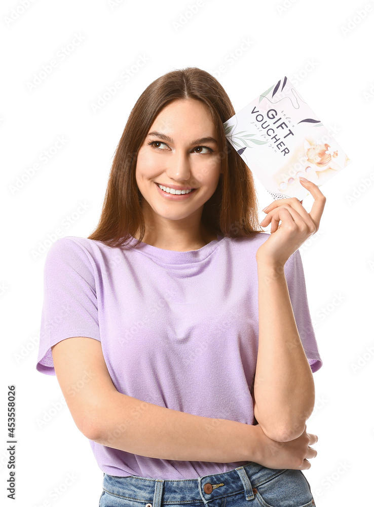 Young woman with gift voucher for massage on white background