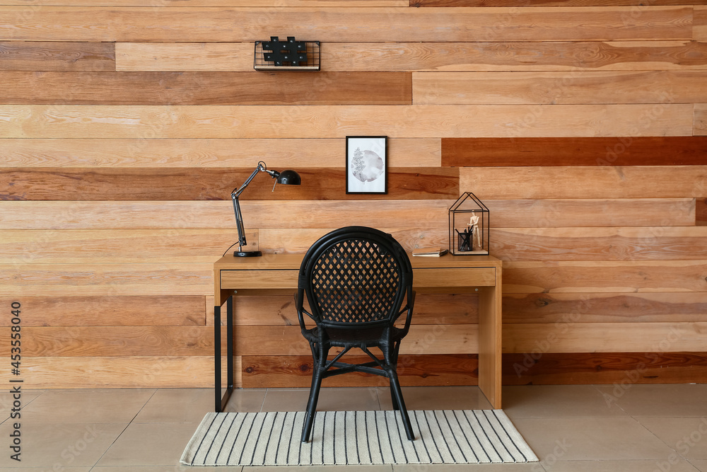 Modern workplace near wooden wall