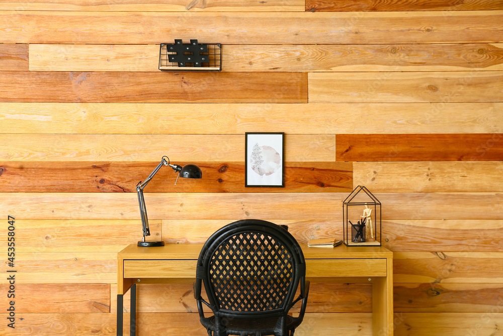 Modern workplace near wooden wall