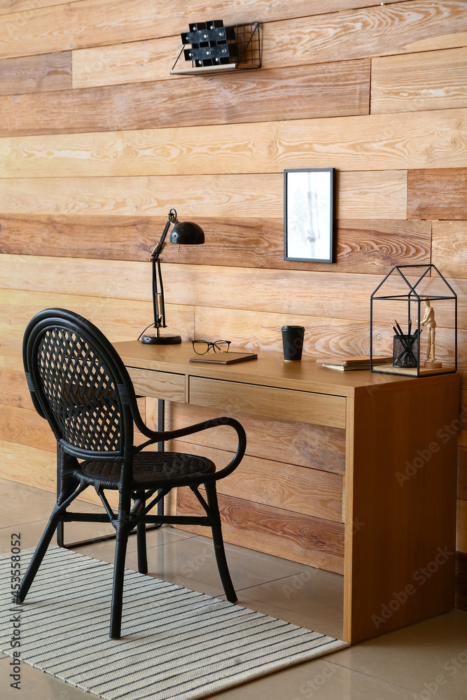 Modern workplace near wooden wall