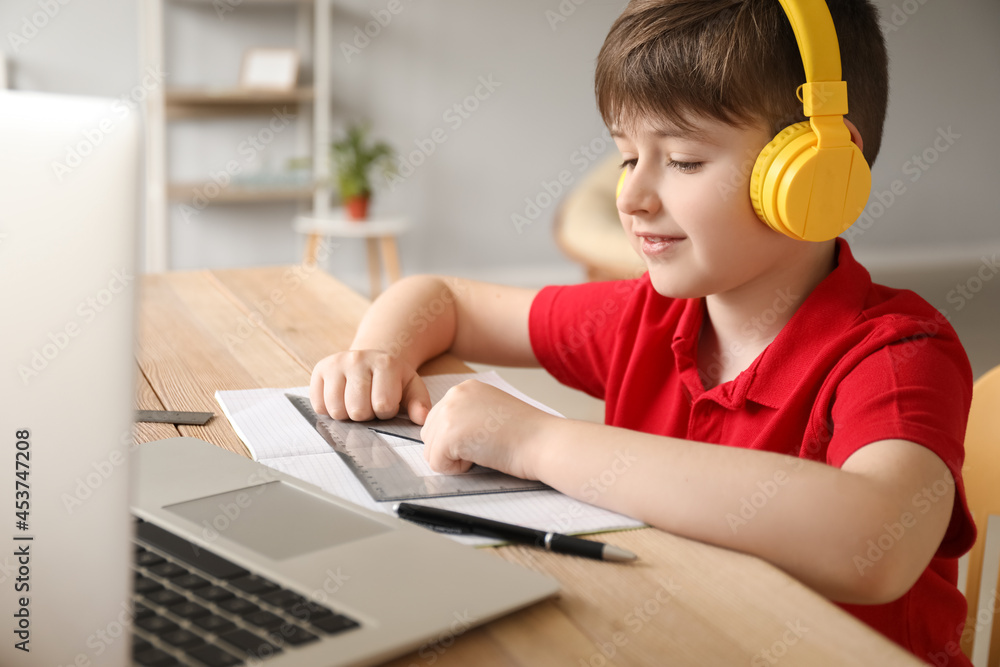 Little boy studying online at home