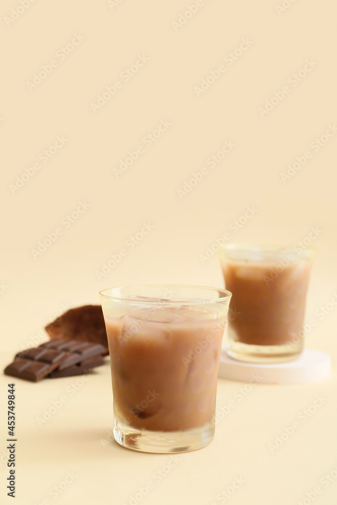 Glasses of tasty chocolate milk on color background