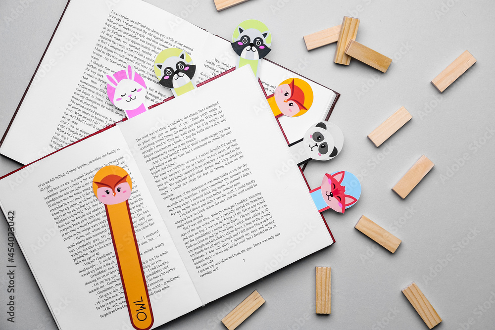 Cute bookmarks with books on grey background