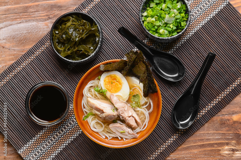 Composition with tasty Chinese soup on wooden background