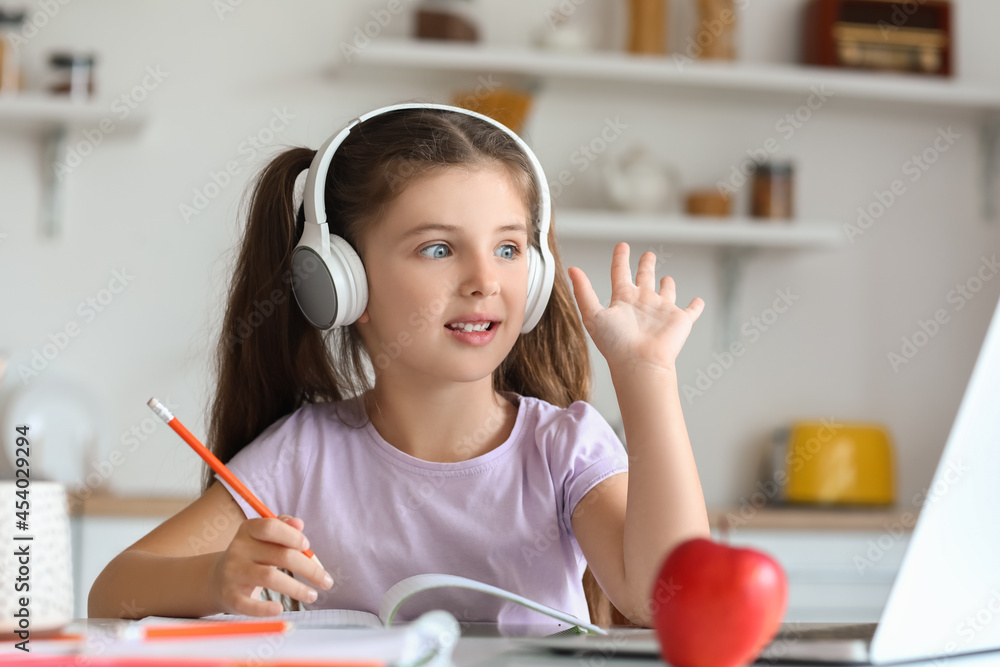 Little girl studying online at home