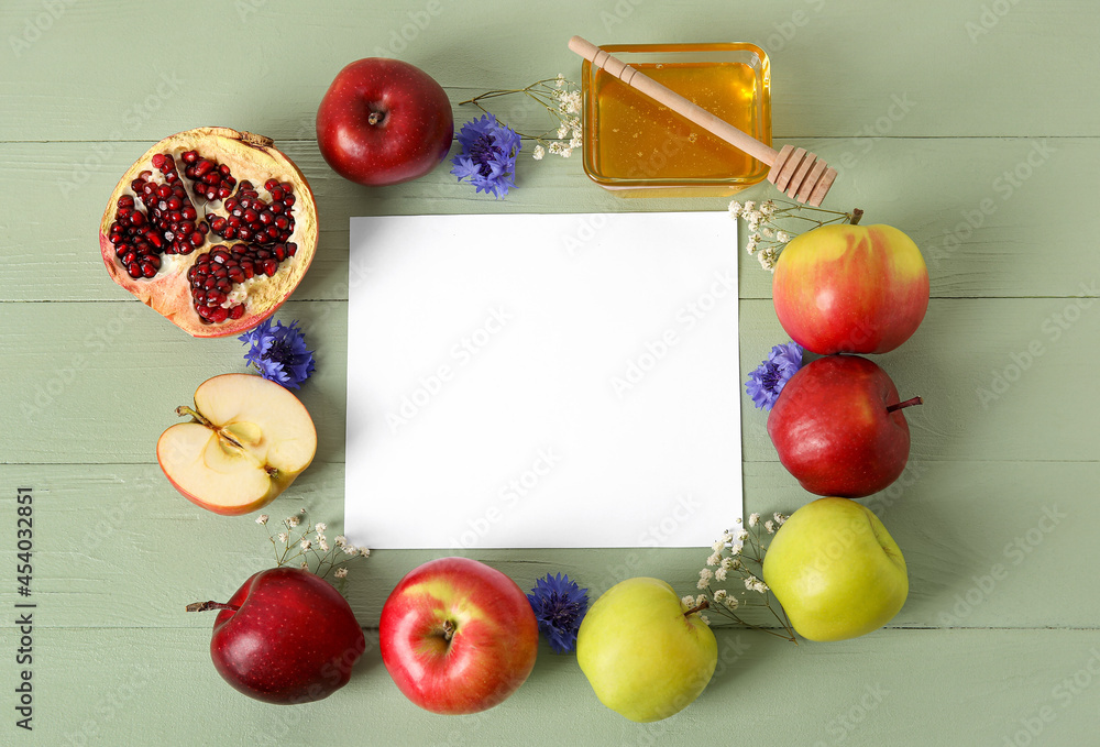 Symbols of Rosh hashanah (Jewish New Year) and empty card on color wooden background