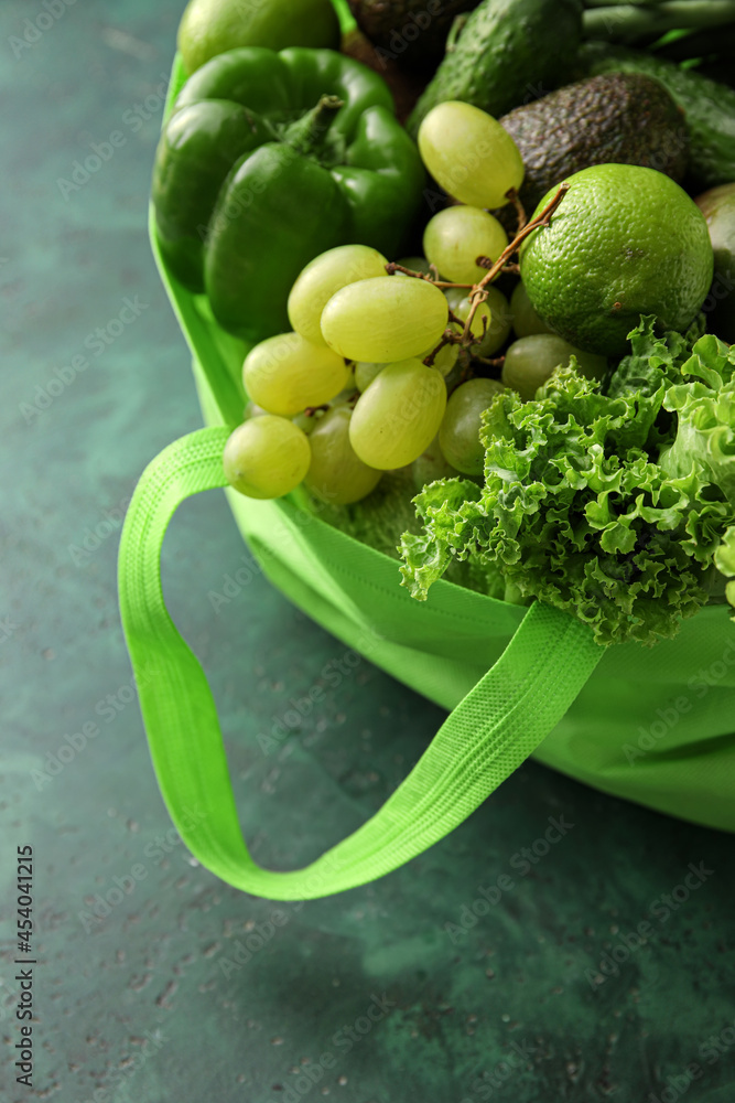 Eco bag with different products on color background