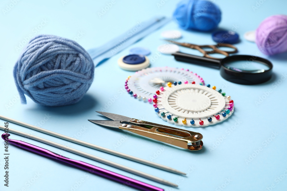 Composition with knitting supplies on color background, closeup