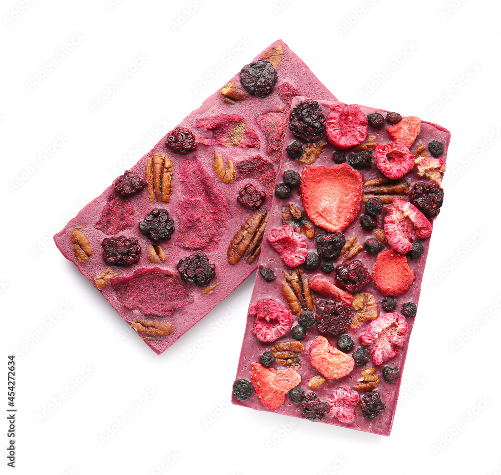 Handmade chocolate bars with fruits, berries and nuts on white background