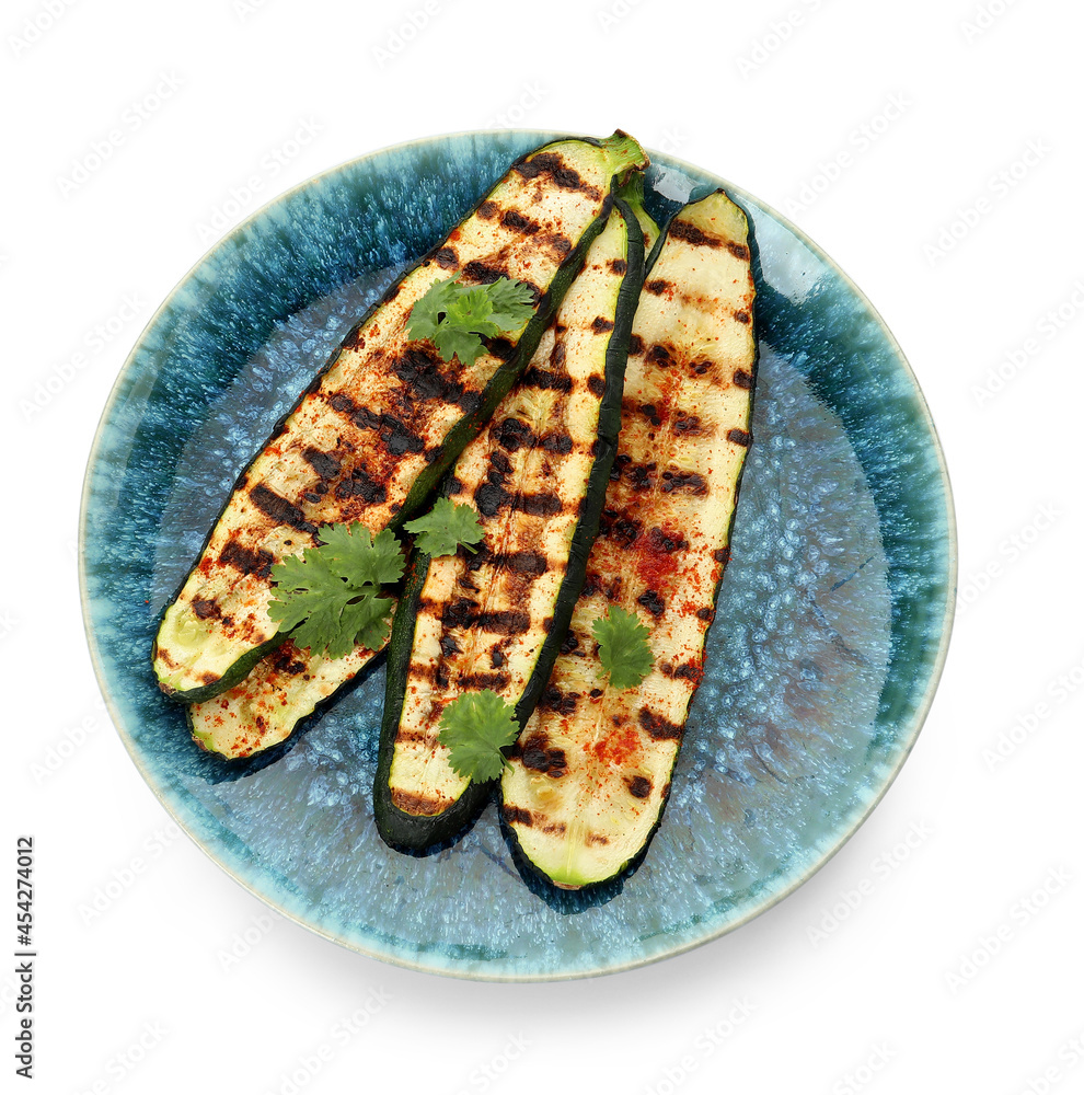 Plate with tasty grilled zucchini on white background