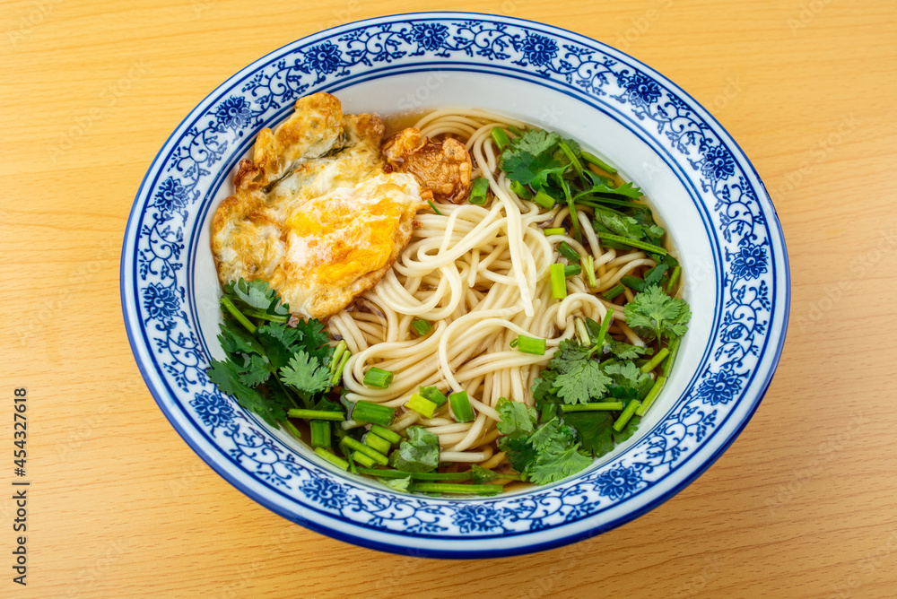 A bowl of egg noodles on the table