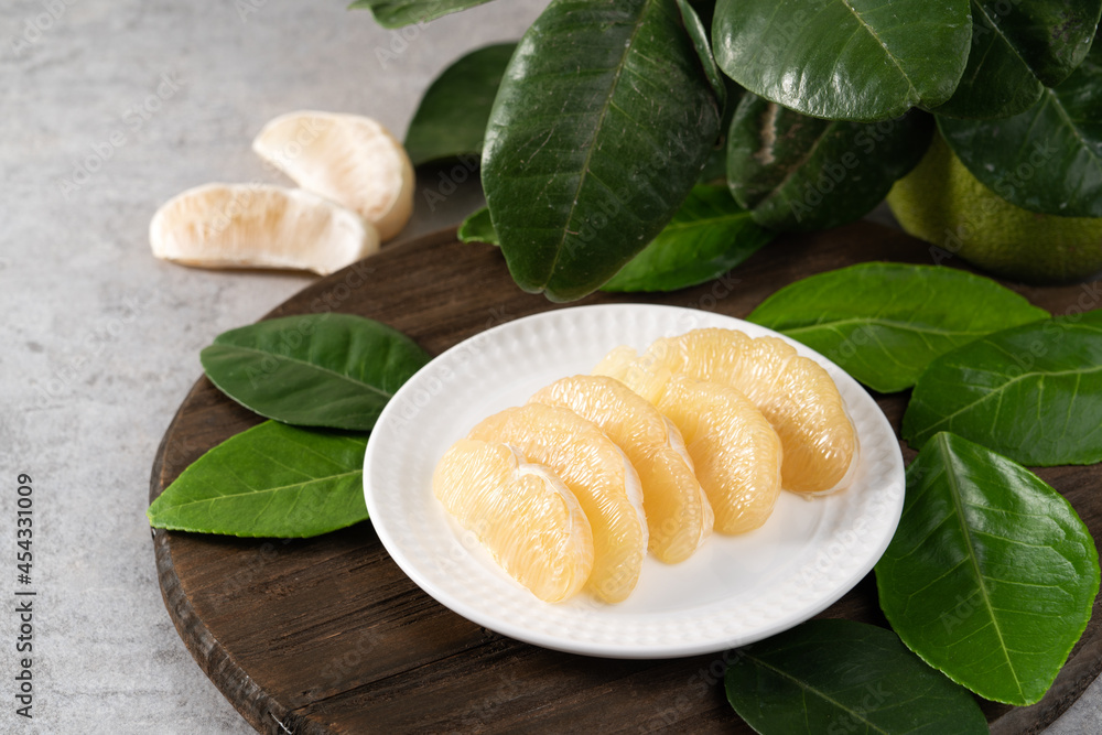 Fresh pomelo fruit on gray cement background.