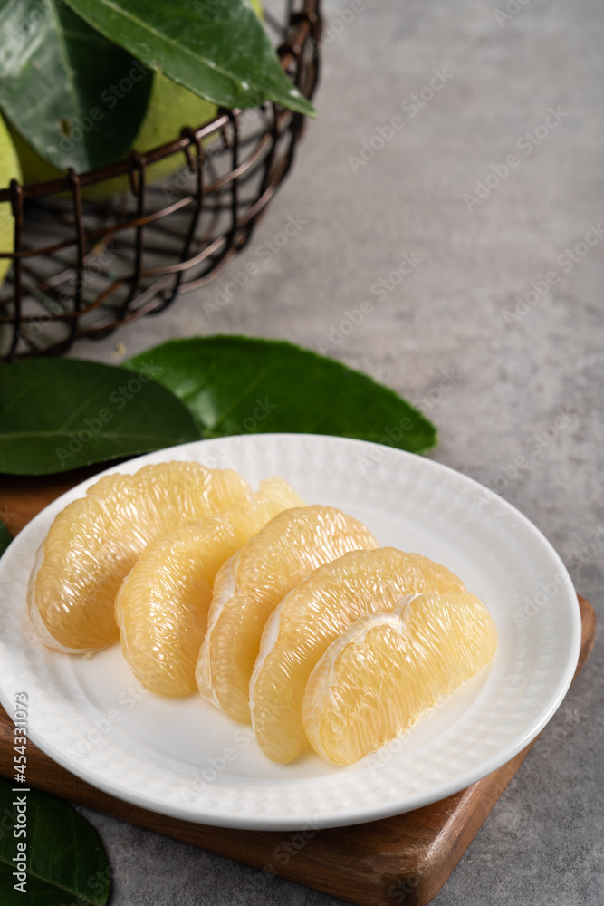 Fresh pomelo fruit on gray cement background.