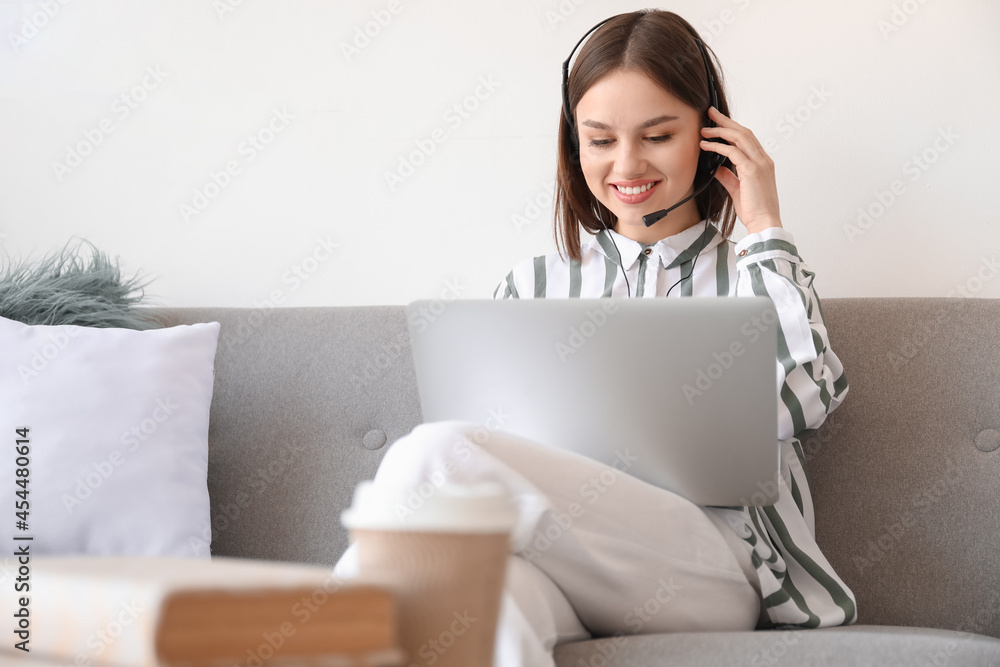 Young woman with laptop at home