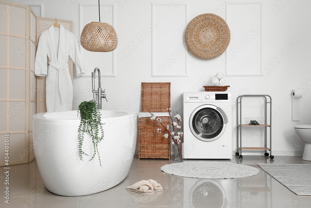 Interior of bathroom with modern washing machine