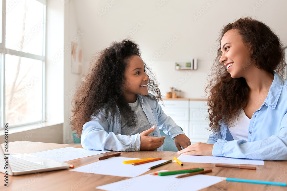 African-American little girl with her mother at home