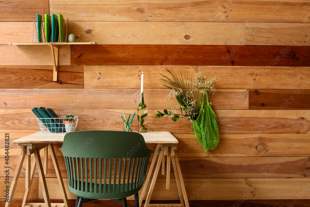 Modern workplace with stationery near wooden wall