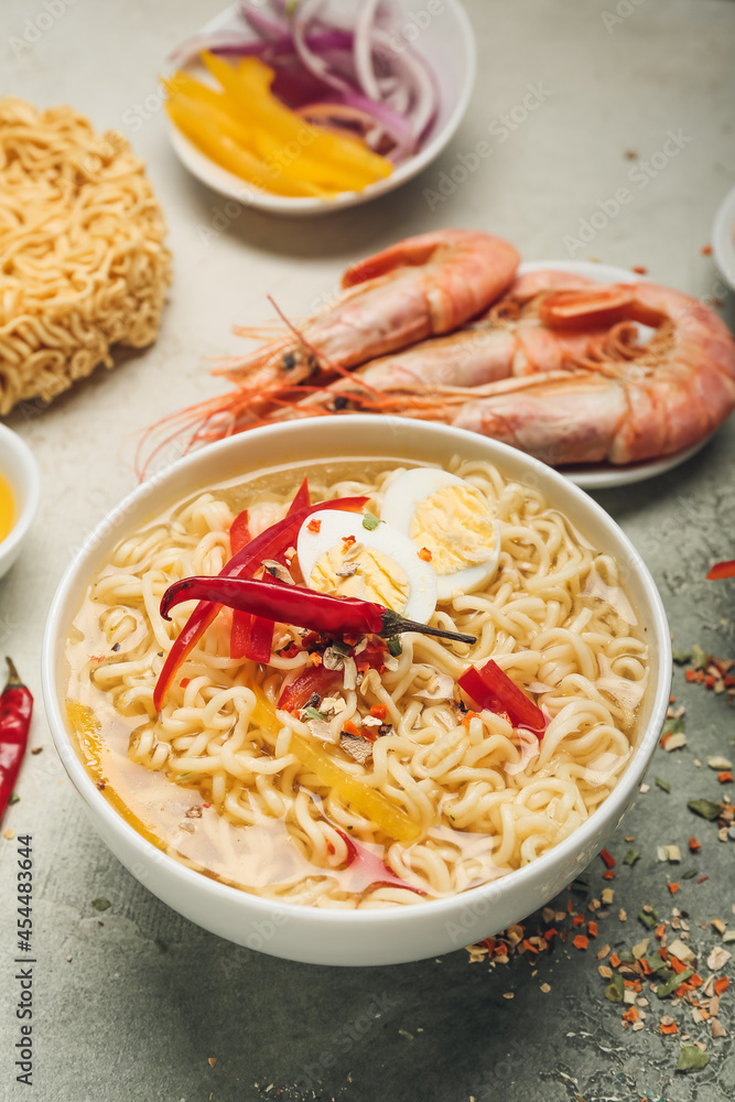 Bowl of tasty Thai soup on table