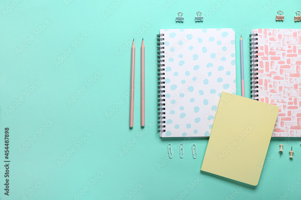 Set of stationery supplies on color background