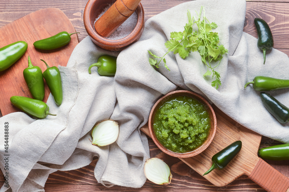 Composition with Tomatillo Salsa Verde sauce on wooden background