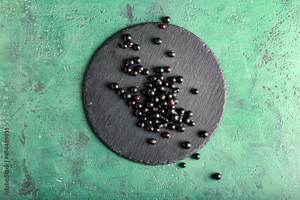 Ripe black currant on color background