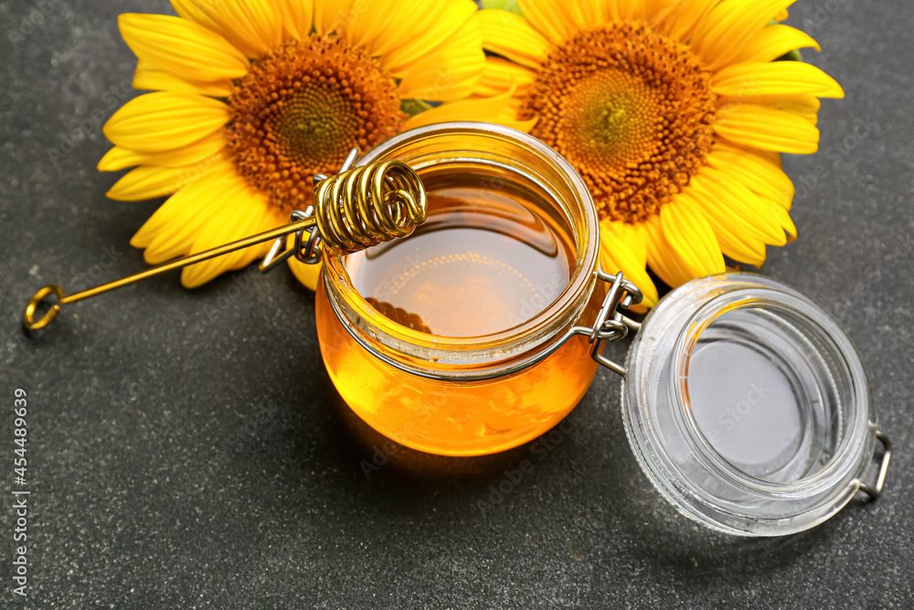 Jar of honey on dark background