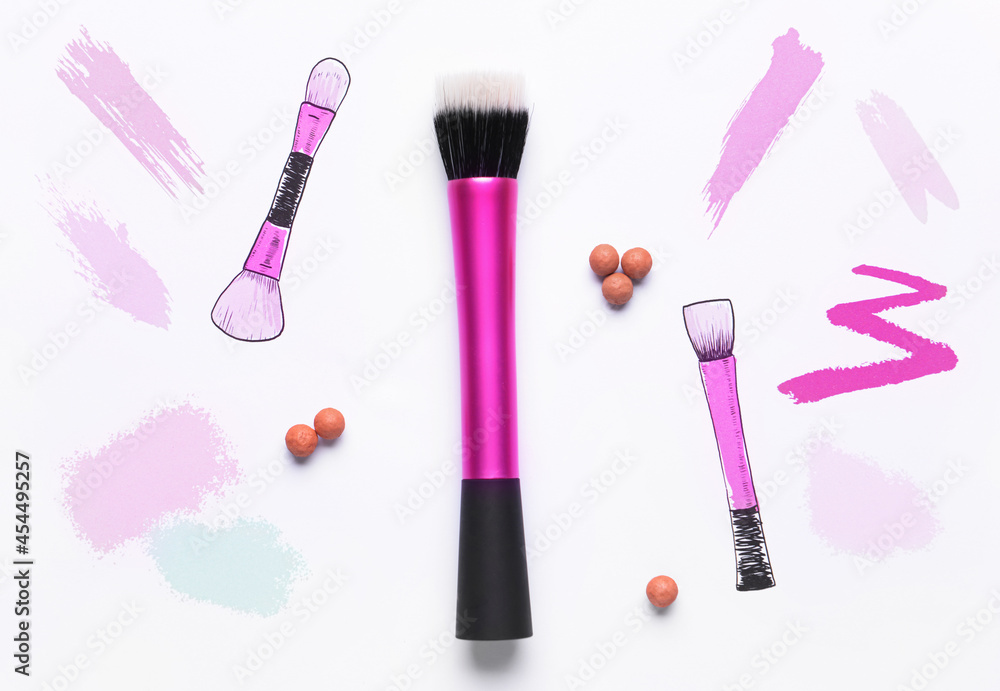 Makeup brush with powder and drawings on white background