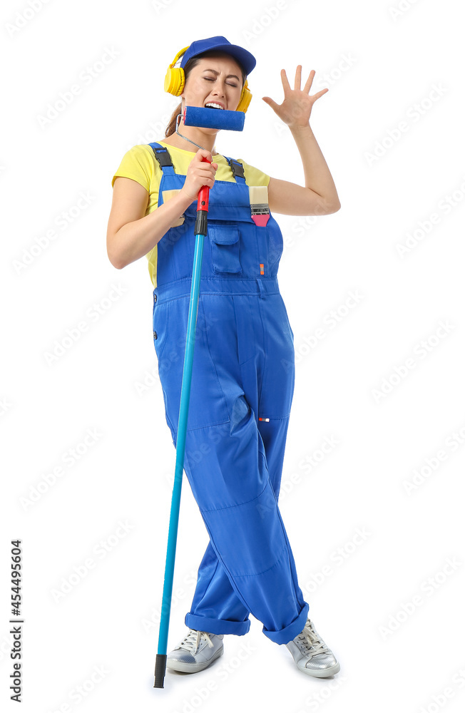 Female painter with roller brush singing on white background