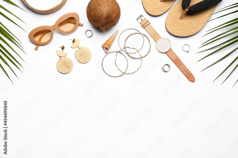 Set of beach accessories and coconut on white background, closeup