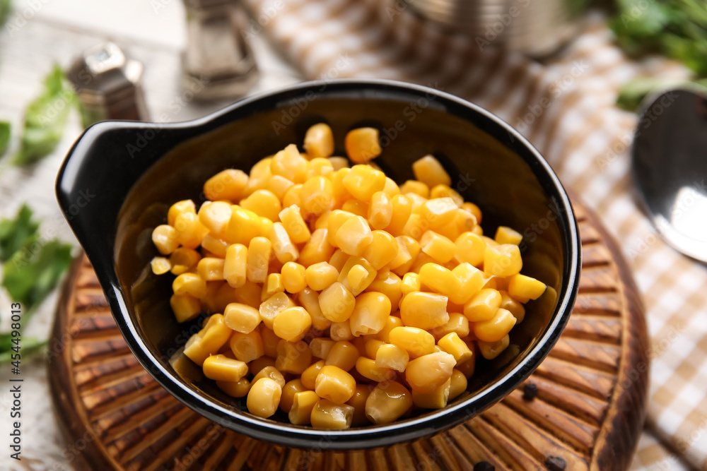 Bowl with corn kernels on table, closeup