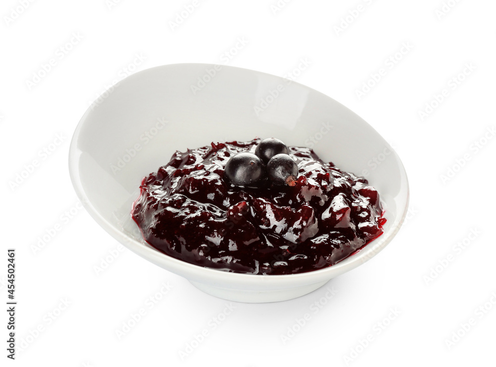 Bowl with black currant jam on white background