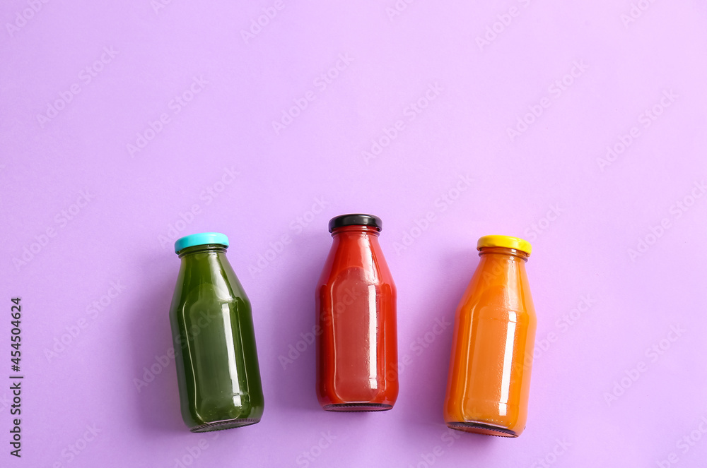 Bottles with healthy juice on color background