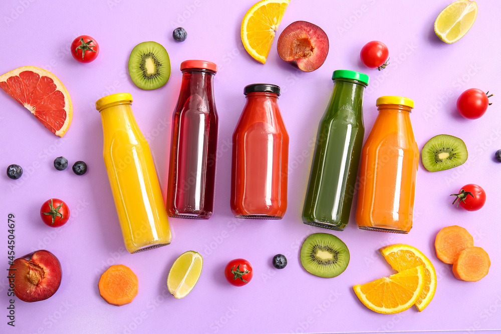 Bottles with healthy juice, fruits and vegetables on color background