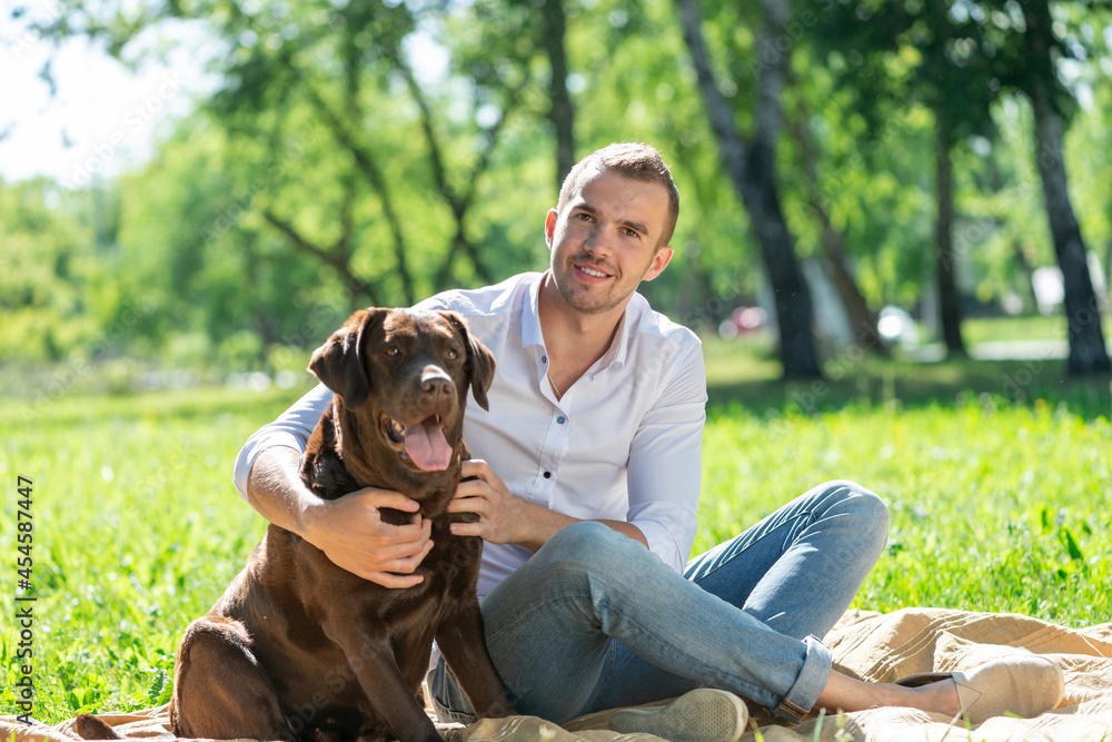 Young man with a dog in the park