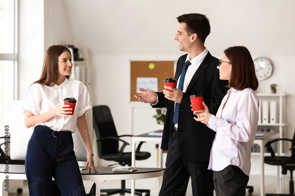 Business colleagues drinking coffee in office