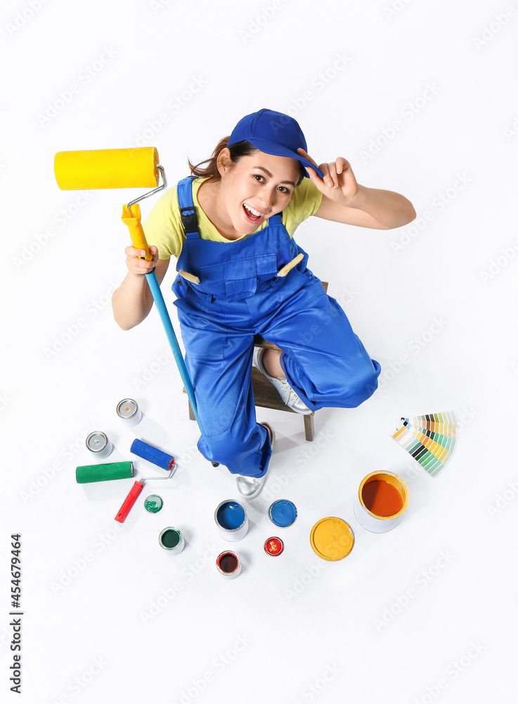 Female decorator with painters tools on white background