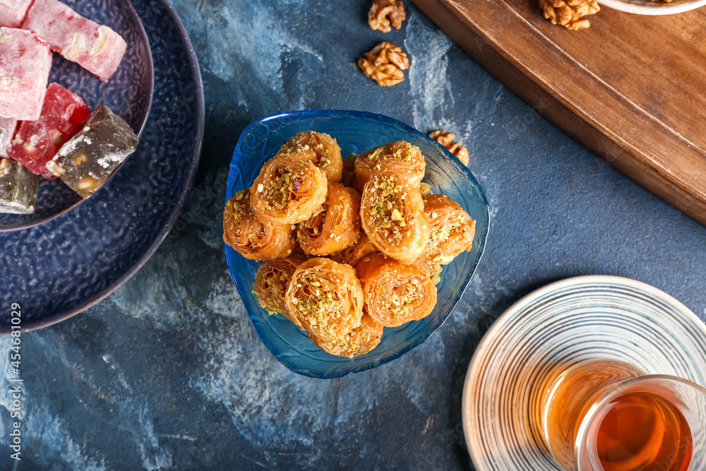 Composition with delicious baklava on color background