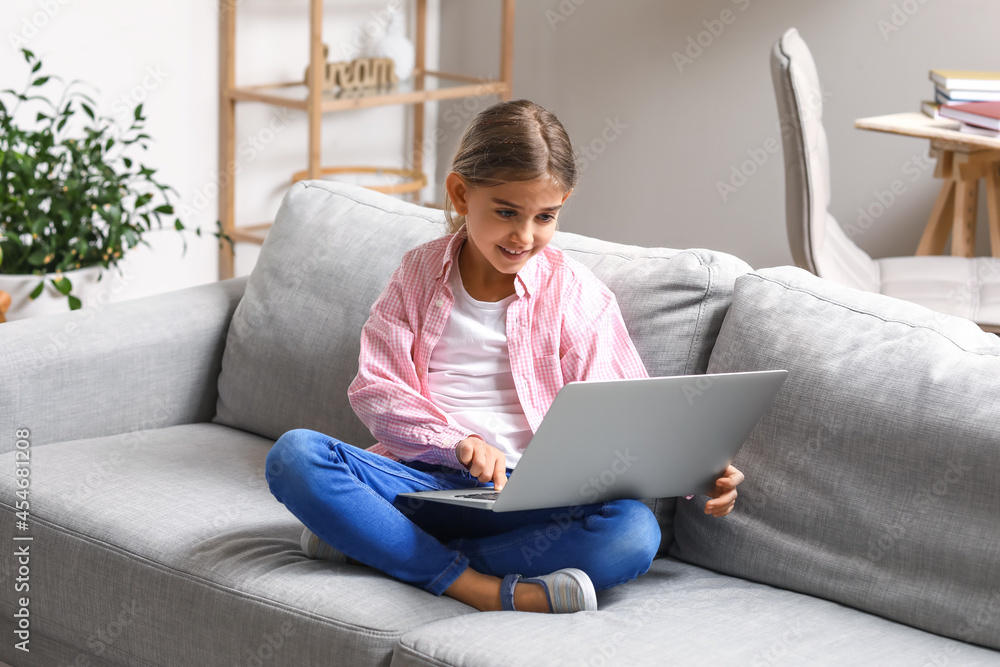 Cute girl watching cartoons at home