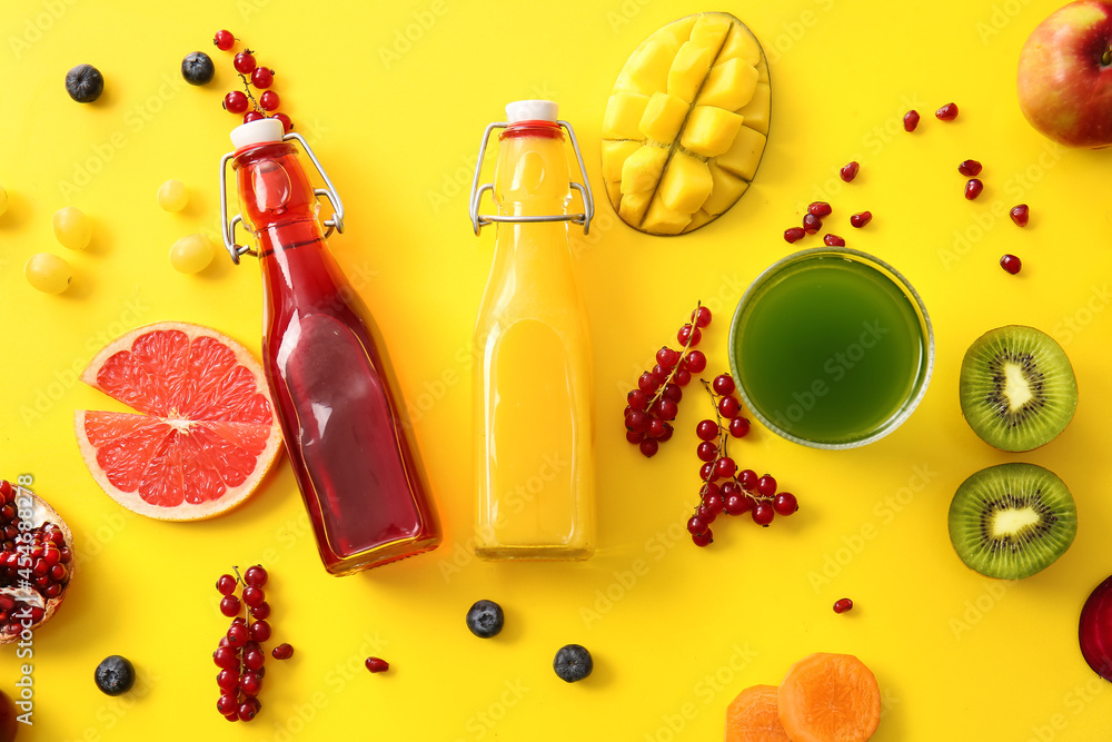 Bottles with healthy juice and fruits on color background