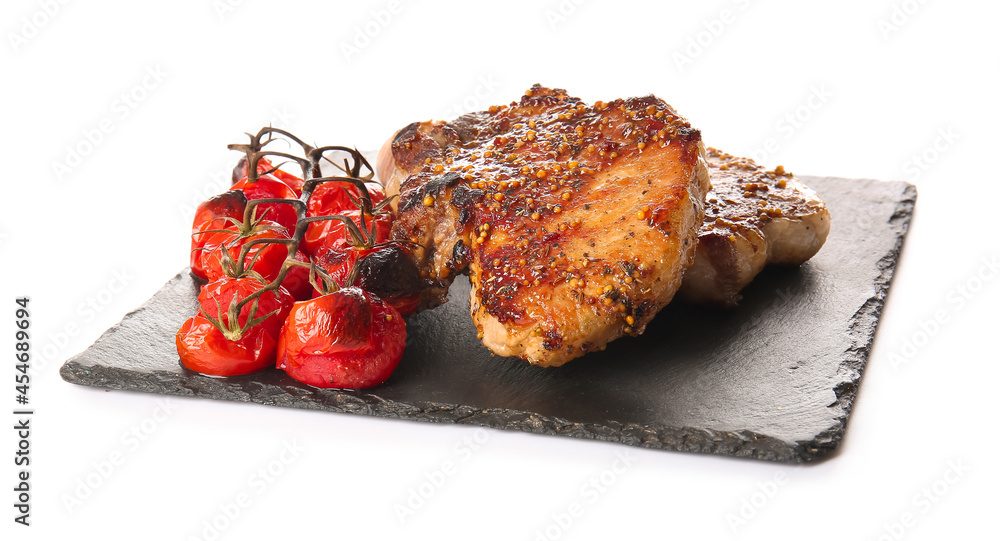 Board with tasty pork steaks and grilled tomatoes on white background