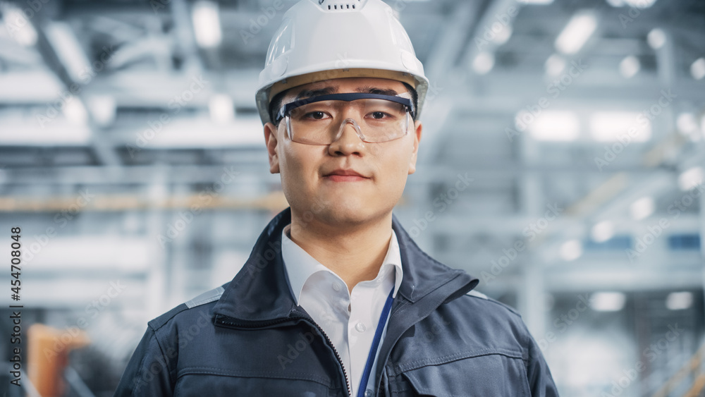 Portrait of a Professional Asian Heavy Industry Engineer Smiling on Camera. Confident Chinese Indust