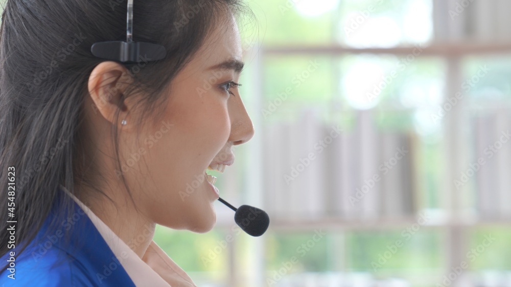 Businesswoman wearing headset working actively in office . Call center, telemarketing, customer supp