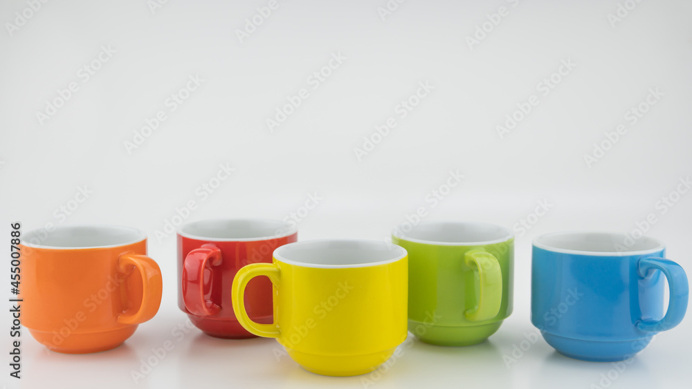 Colorful coffee cup on colorful paper background A lot of cups for coffee and tea in coffee shop Foo