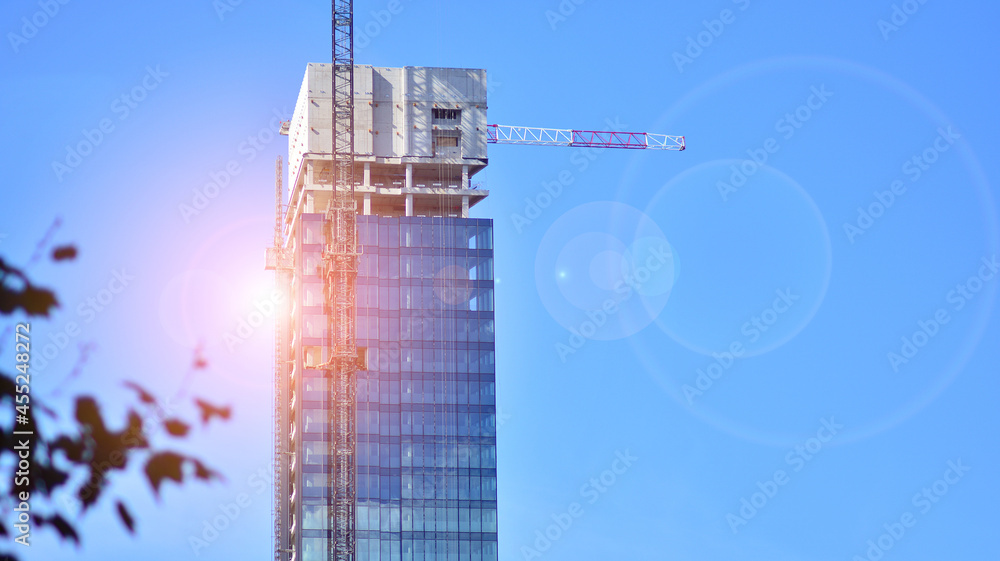 High-rise building under construction. Modern office building. Sunrise.