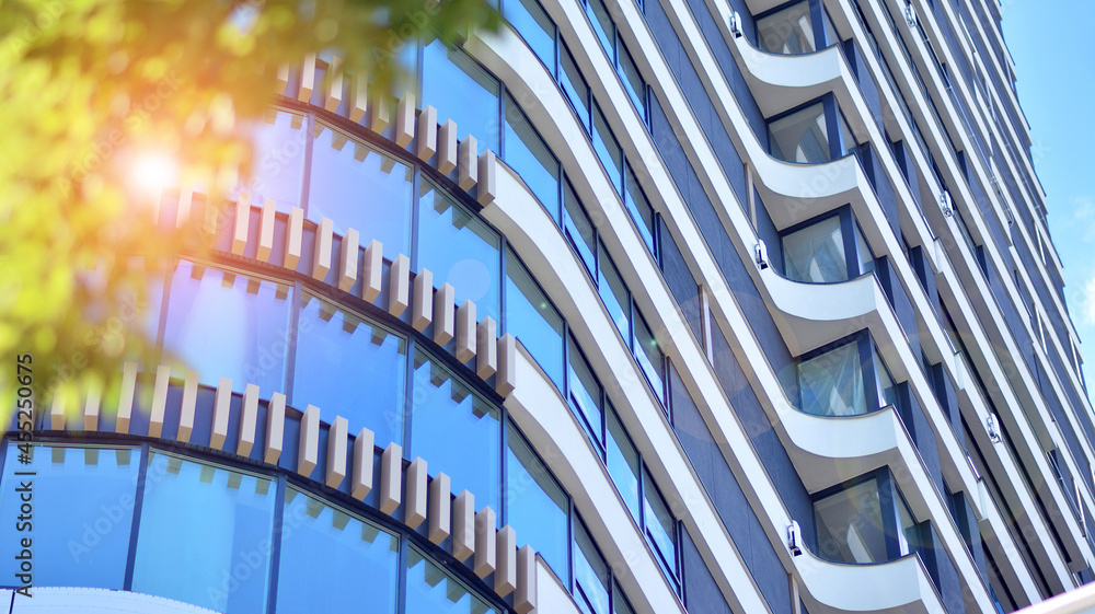 Eco architecture. Green tree and new apartment building. The harmony of nature and modernity.