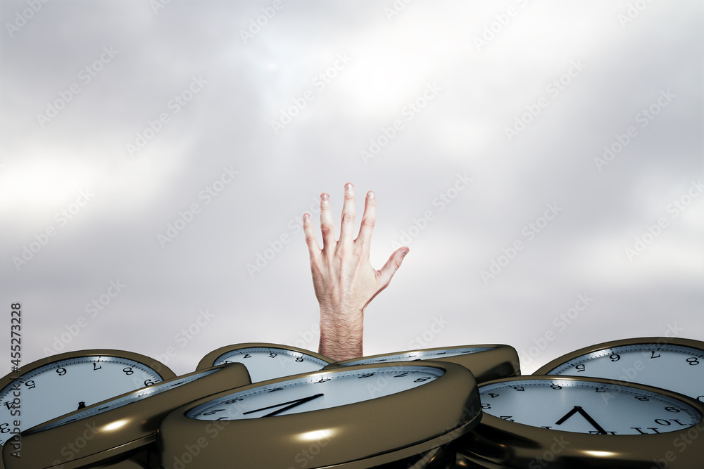 Male hand reaching for help from under pile of clocks. Deadline concept.