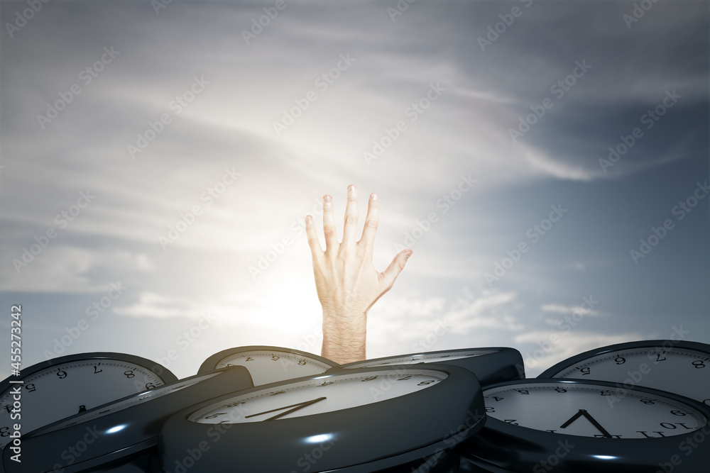 Man hand reaching for help from under pile of clocks. Deadline concept.