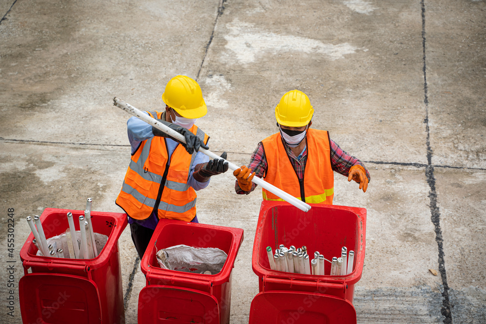 Waste collectors at work,Garbage removal worker in protective clothing working for a public utility 